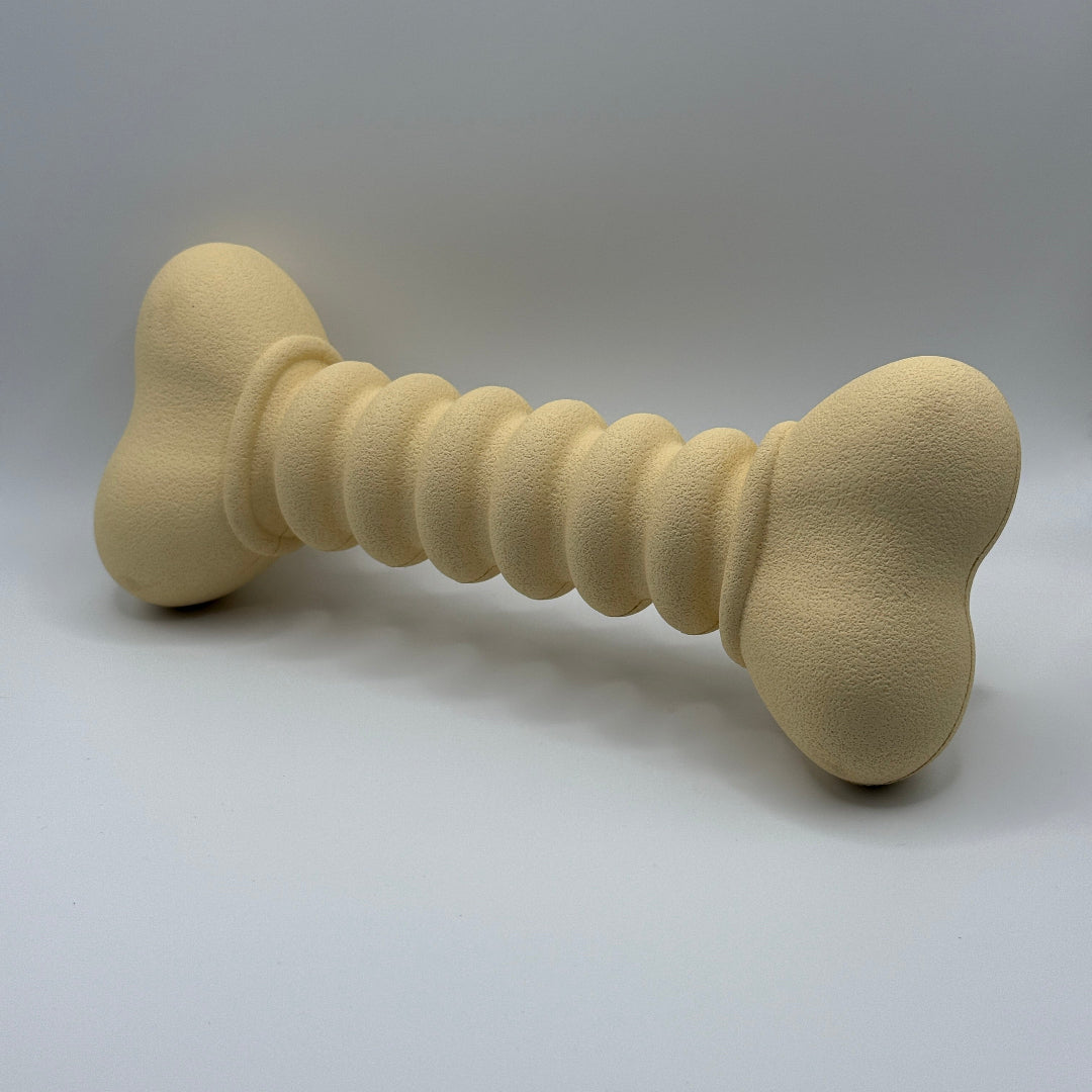 Ribbelbot hondenspeelgoed van natuurlijk rubber – paars of beige, ribbelstructuur beige schuin voorkant